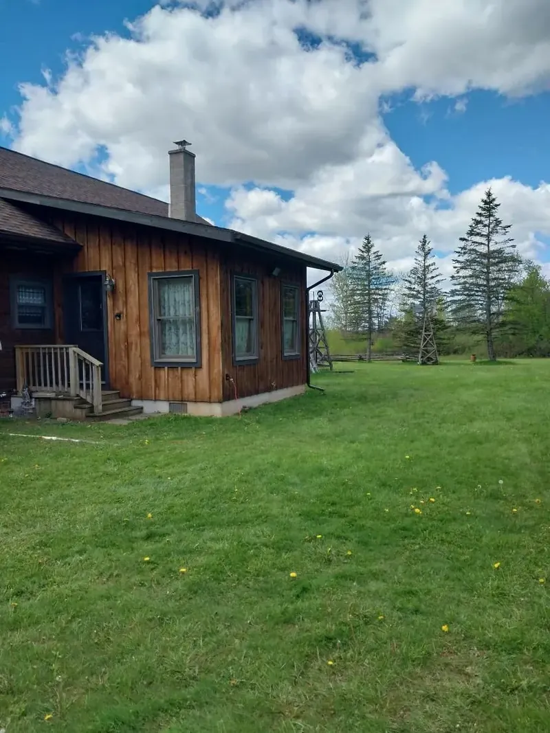Log home with a metal roof in Central New York, resealed and repainted