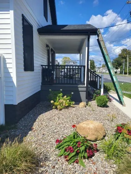 Porch railings, trim and siding finished on a front entry