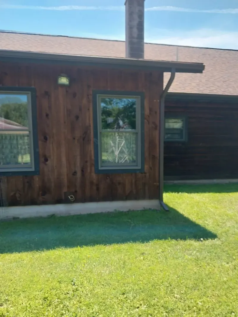 Exterior work on a stained wood-sided home
